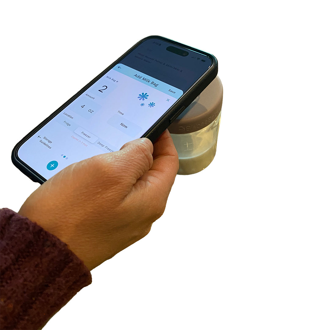 Parent tapping smartphone to BisbeeBaby glass breast milk jar with NFC lid to log milk in the Cubtale app.